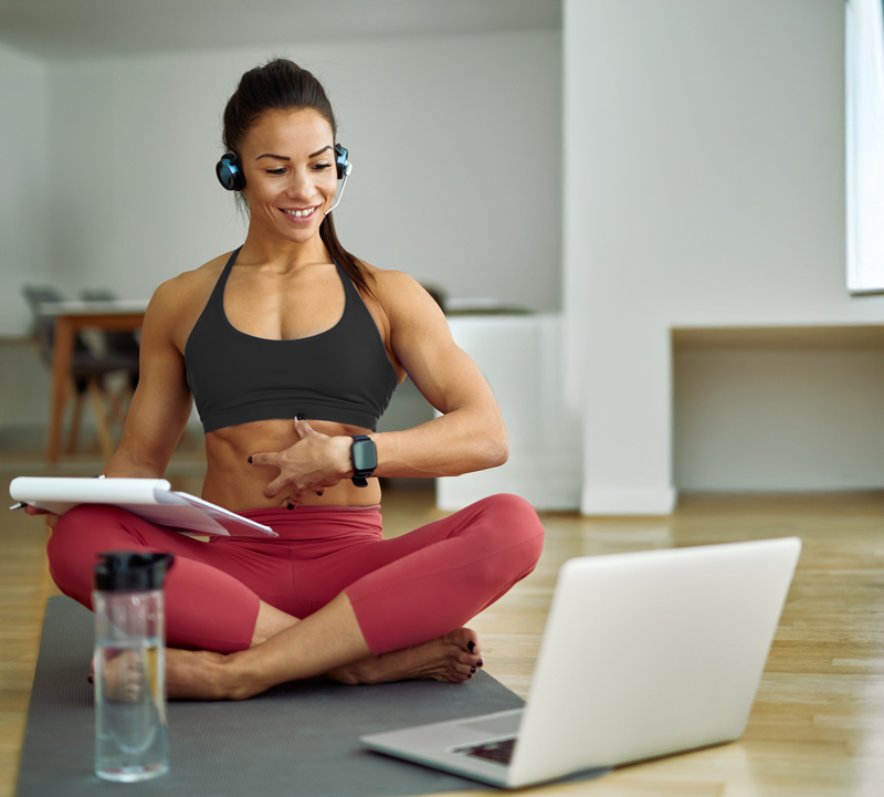 bio3 academie happy fitness instructor advising her clients about abs exercises while using laptop home