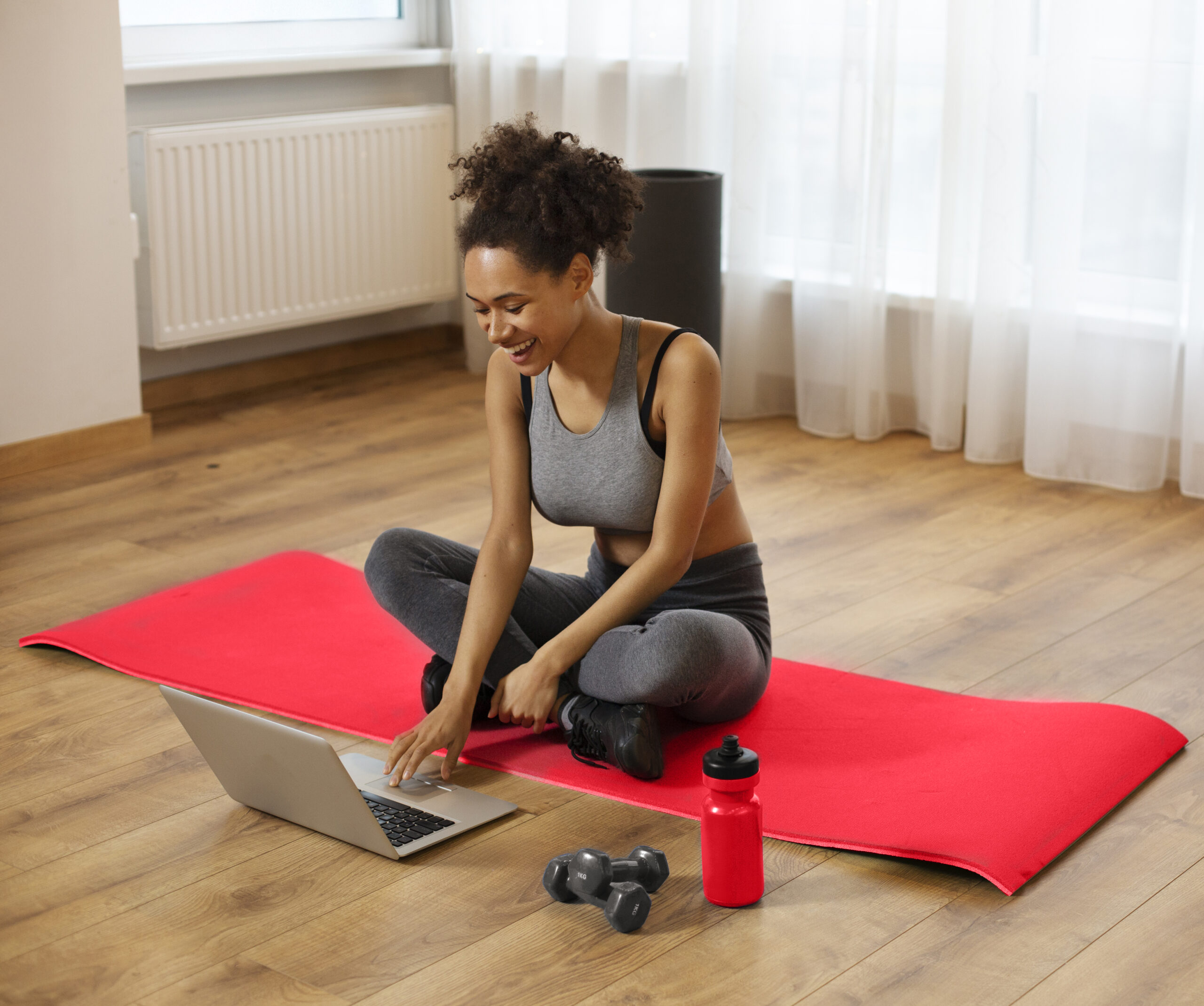 medium shot woman working out with laptop scaled