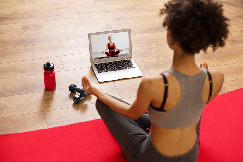 medium shot woman working out with laptop copy